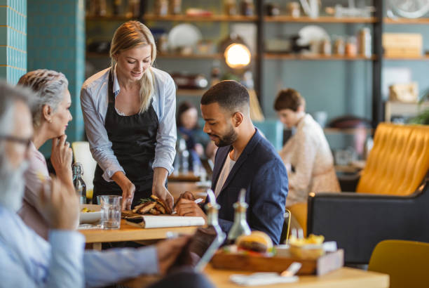 istock Diverse Professionals Engaging in Bistro Business Meeting 2194609175