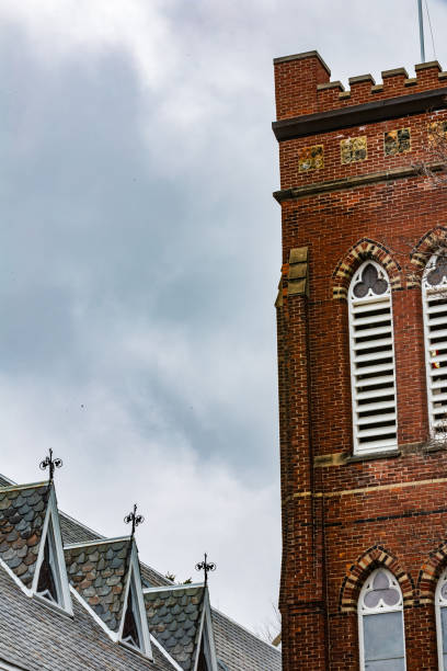 istock Gothic Architecture Featuring Brick Tower and Tiled Roof Under Cloudy Sky 2194609510