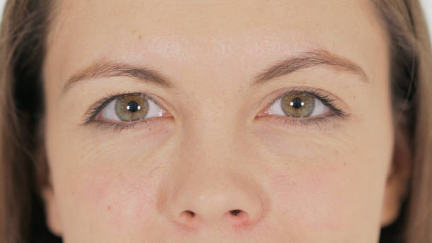 istock Close up of Female Blinking Eyes on White Background 2194610742