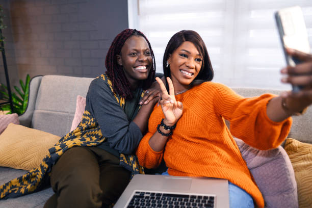 istock Two smiling young women taking a selfie on the couch at home 2194610889