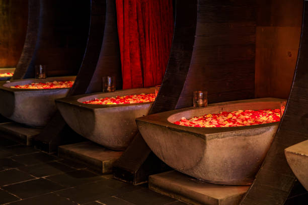 Stone baths with rose flower petals at a luxury spa creating a relaxing ambiance