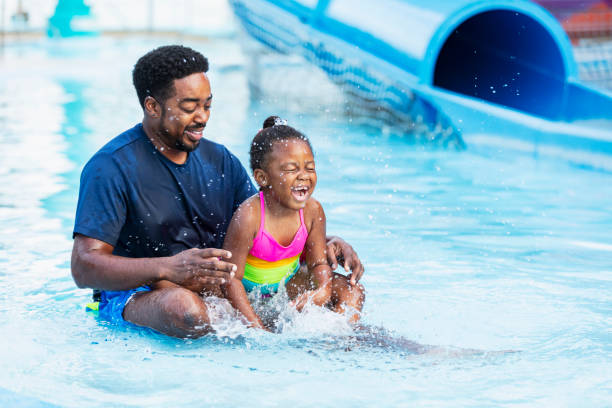 istock African-American father, daughter laughing in pool 2194612207