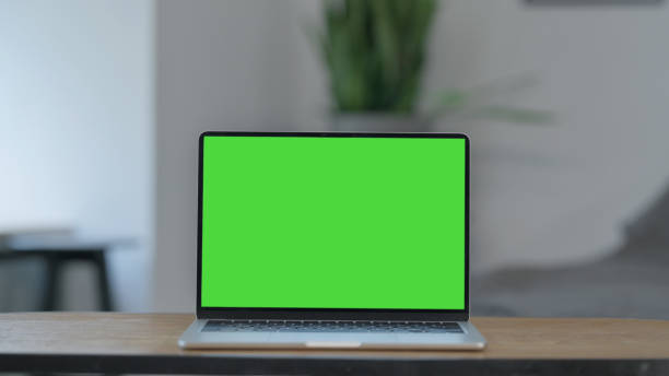 istock Laptop with Green Screen on Desk at Home 2194620267