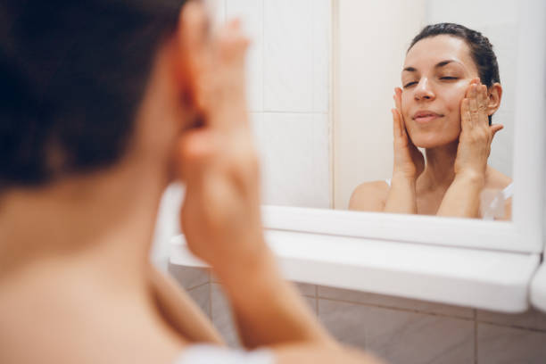 istock Beautiful woman using beauty cosmetics on face. 2194622037