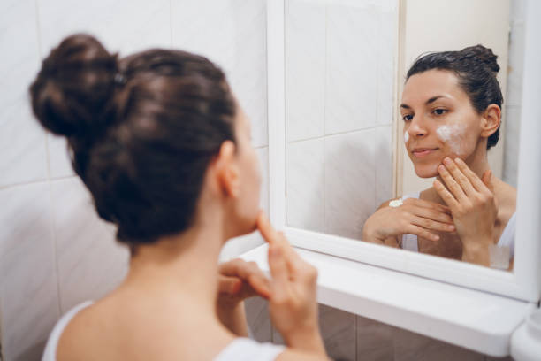 istock Beautiful woman using beauty cosmetics on face. 2194622065