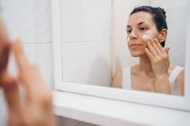 istock Beautiful woman using beauty cosmetics on face. 2194622080