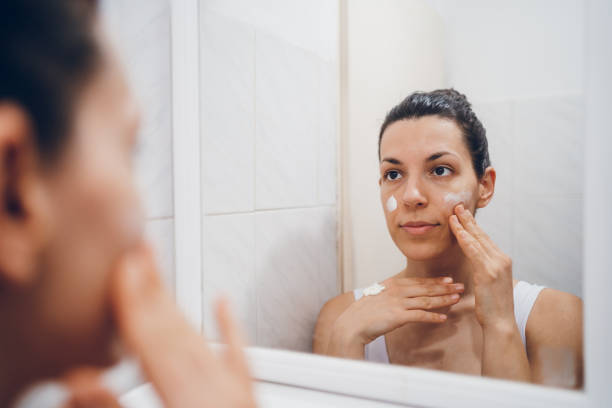 istock Beautiful woman using beauty cosmetics on face. 2194622113