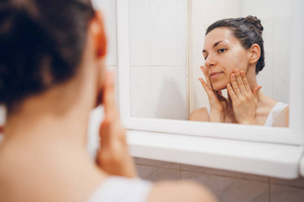 istock Beautiful woman using beauty cosmetics on face. 2194622147