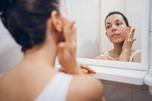 istock Beautiful woman using beauty cosmetics on face. 2194622293