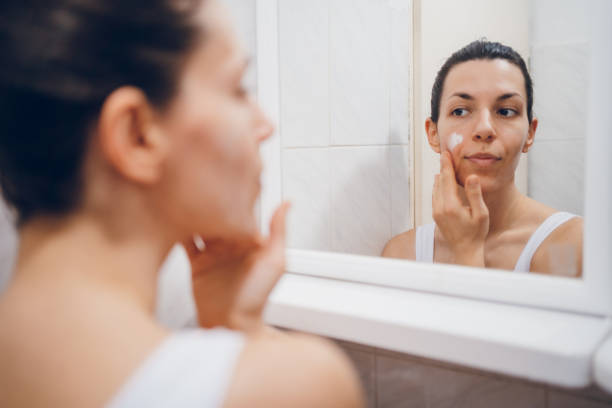 istock Beautiful woman using beauty cosmetics on face. 2194622350