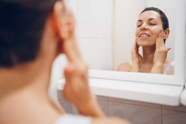 istock Beautiful woman using beauty cosmetics on face. 2194622402