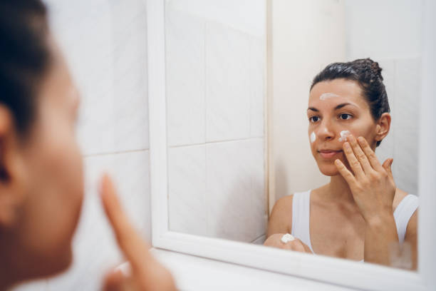 istock Beautiful woman using beauty cosmetics on face. 2194622417