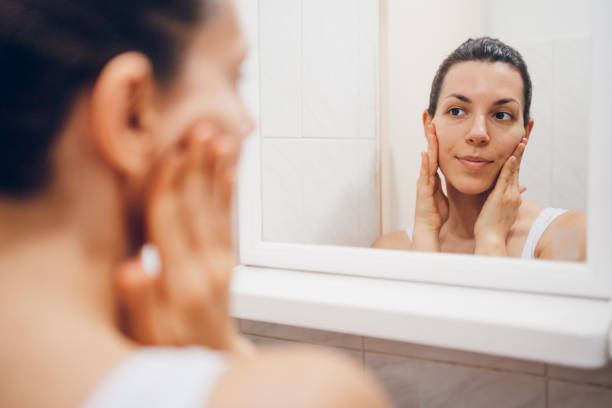 istock Beautiful woman using beauty cosmetics on face. 2194622509