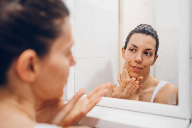 istock Beautiful woman using beauty cosmetics on face. 2194622529