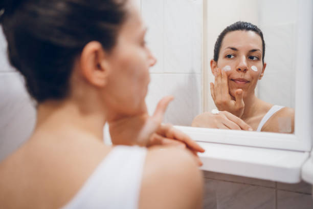 istock Beautiful woman using beauty cosmetics on face. 2194622580