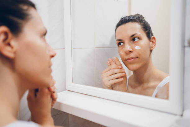 istock Beautiful woman using beauty cosmetics on face. 2194622606