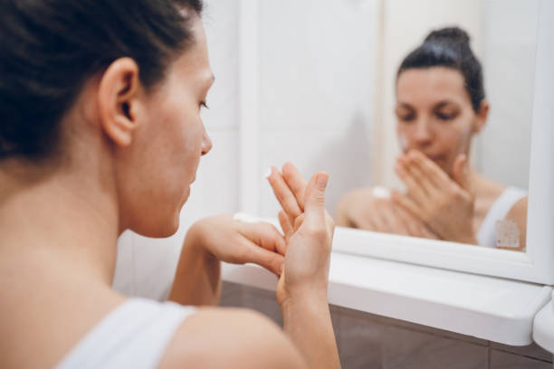 istock Beautiful woman using beauty cosmetics on face. 2194623188