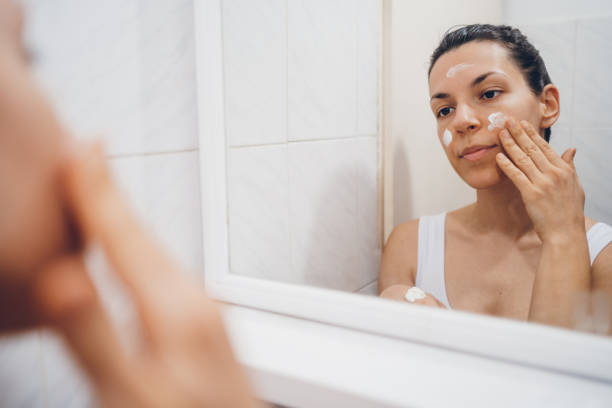 istock Beautiful woman using beauty cosmetics on face. 2194623194