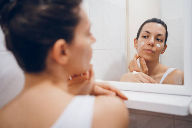 istock Beautiful woman using beauty cosmetics on face. 2194623211