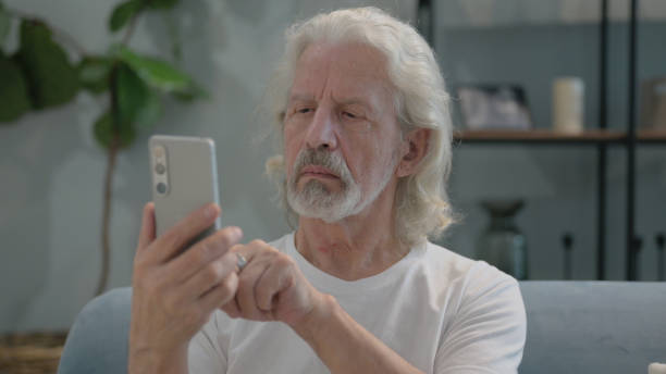 istock Portrait of Old Man Using Phone at Home 2194623310