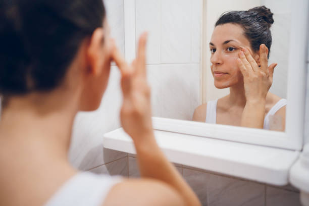 istock Beautiful woman using beauty cosmetics on face. 2194623456
