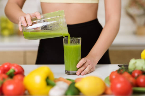 istock Freshly Squeezed Green Juice Being Poured Into a Glass in a Kitchen Setting 2194623539