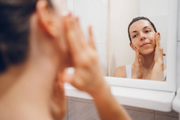 istock Beautiful woman using beauty cosmetics on face. 2194623553