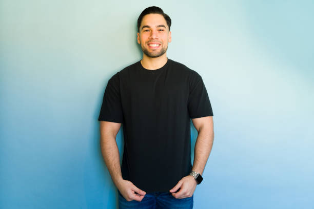 istock Handsome hispanic man smiling and posing on blue background 2194624330
