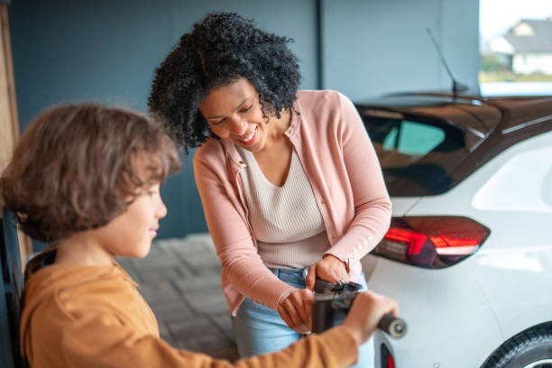 istock Hispanic Mother and Mixed Race Boy Adjusting E-Scooter Near Home 2194629820