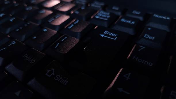 istock Close-up of computer keyboard in dark background. 2194629850