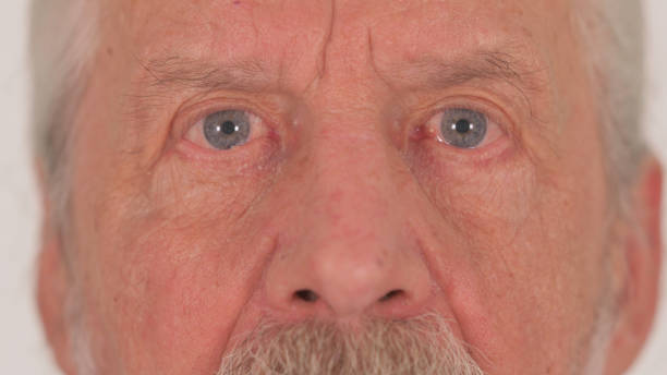 istock Close up of Old Male Blinking Eyes on White Background 2194632610