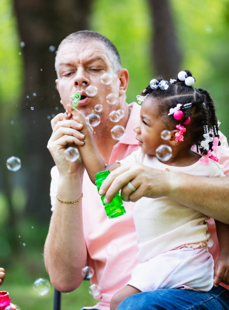 istock Father and daughter playing with bubble wand 2194633905