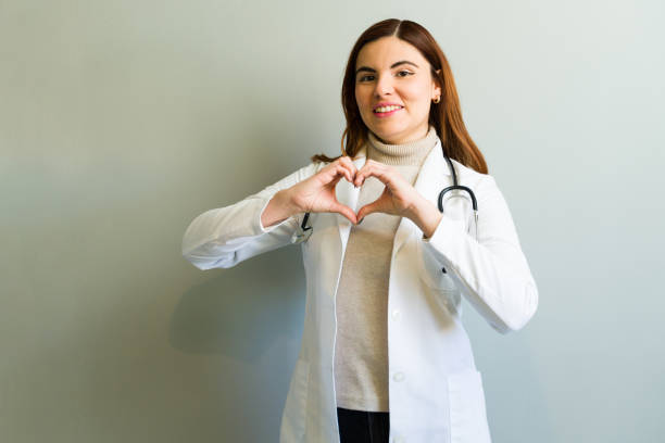 istock Attractive female doctor making heart shape with hands 2194634626
