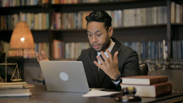 istock Middle Aged Lawyer Doing Paperwork with Laptop 2194635194