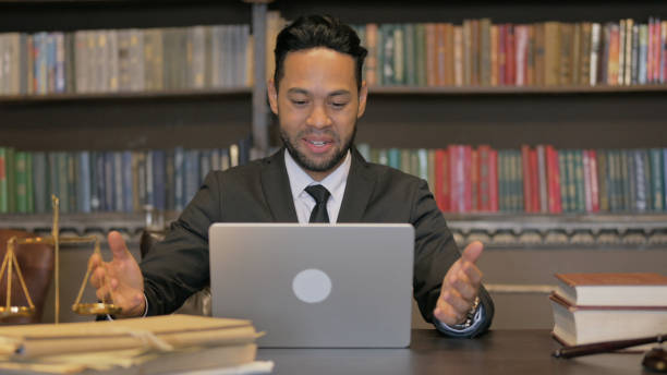 istock Hispanic Judge Doing Video Chat on Laptop 2194635209