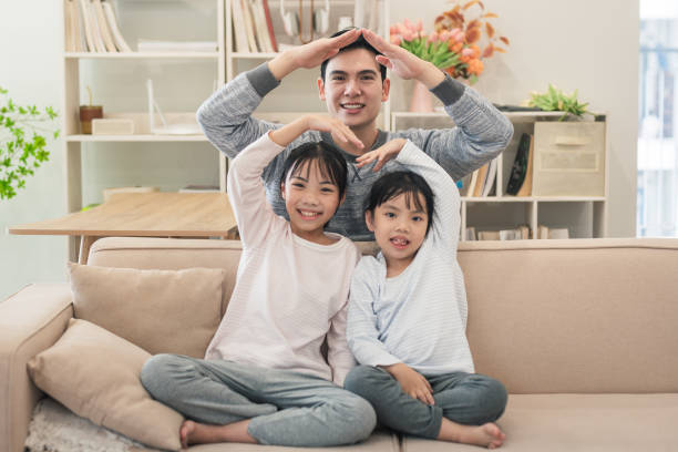 istock Asian father and two daughters at home 2194637385