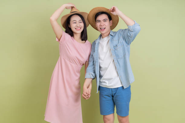 istock Young Asian couple on green background 2194637614