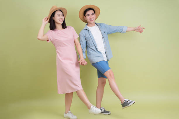 istock Young Asian couple on green background 2194637615