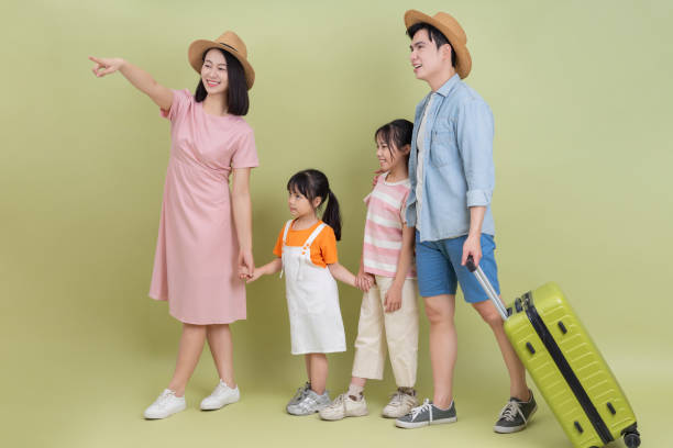 istock Young Asian family on green background 2194637616