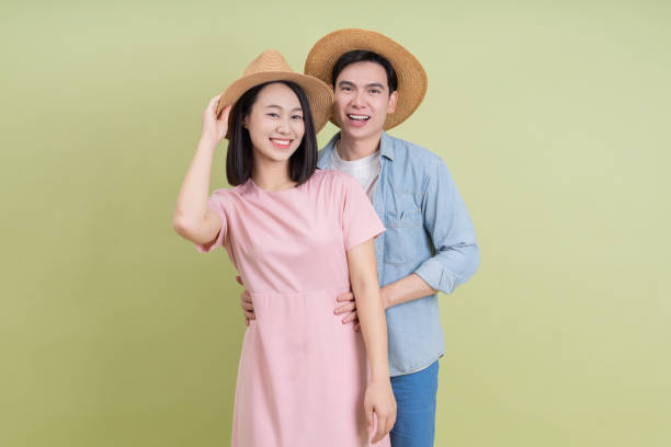 istock Young Asian couple on green background 2194637618