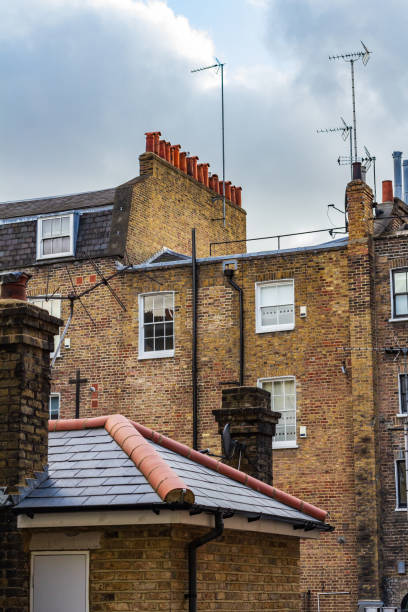 istock Brick Urban Rooftops with Chimneys and Antennas Under a Cloudy Sky 2194637657