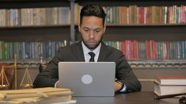 istock Pensive Hispanic Judge Working on Laptop 2194638854