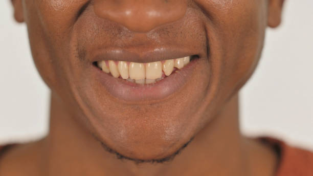 istock Close up of Smiling African Male Lips on White Background 2194639721