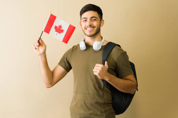 istock Happy latin student holding canadian flag and backpack 2194639895