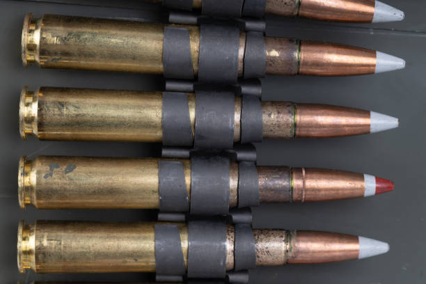 istock .50 BMG caliber machine gun ammunition belt with cartridges in ammunition can. 2194640860