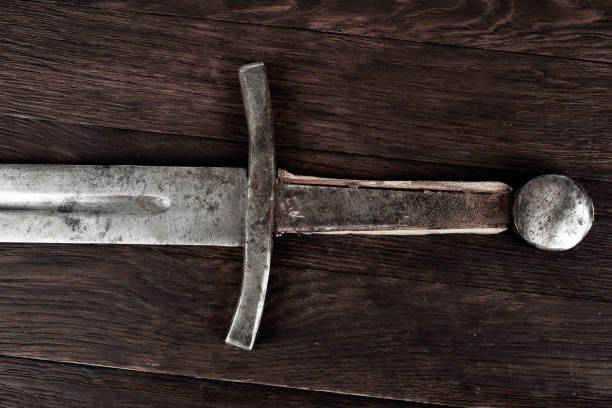 istock Medieval sword on wooden backgrond. 2194640932