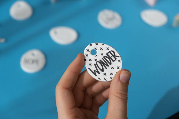 istock Workshop writing word WONDER on EASTER egg Unrecognizable artist do it yourself air dry clay crafts for Easter holiday. Decoration gift idea Handmade children craft. Step by step instruction of painting, pressing figures 2194641535