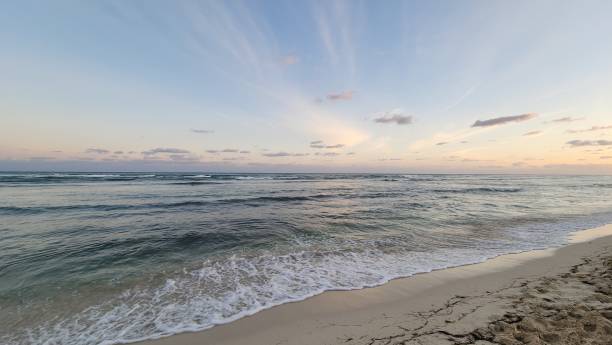 istock Beautiful sunset at tropical beach with moody sky and clouds 2194641959