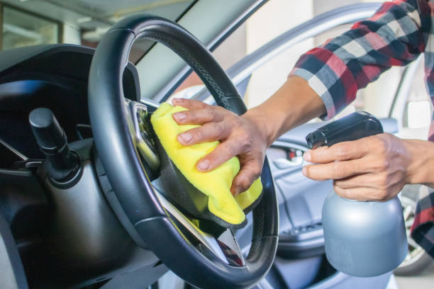 istock A man's hands are wiping the interior of a car. 2194644948