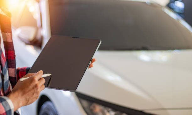 istock A man's hand is holding a tablet in a car insurance agent parking garage. 2194644970